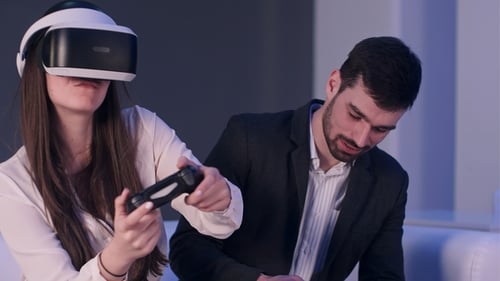 Woman Plays VR Game as Man Uses Phone