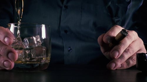 Whiskey Pour with Cigar in Moody Lighting