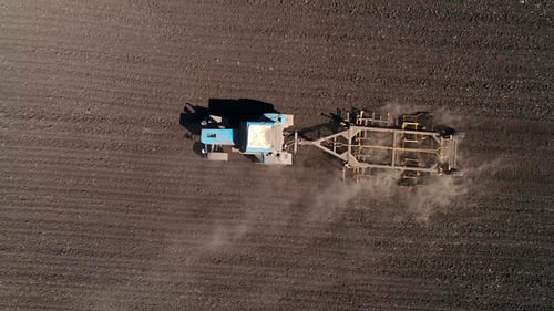 Aerial View of Agricultural Tractor Cultivating Field