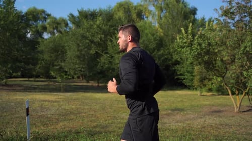 Man Running Through the Park on Sunny Day