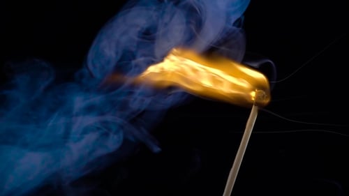 Burning Matchstick with Blue Smoke on Black