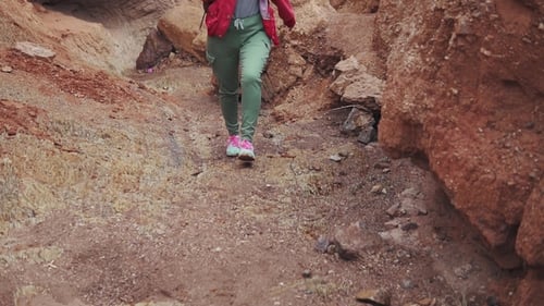 Woman Hikes Through Striking Desert Landscape