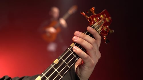 Hand Playing Electric Bass Guitar Close Up