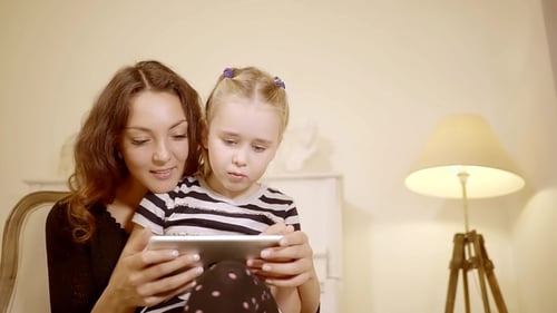 Mother and Daughter Watching Tablet Together