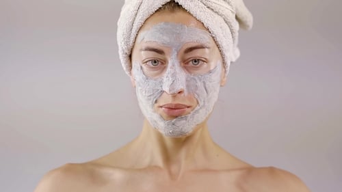 Woman with face mask treatment smiling