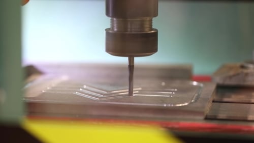 Industrial Machine Cuts Geometric Shapes into Metal Plate