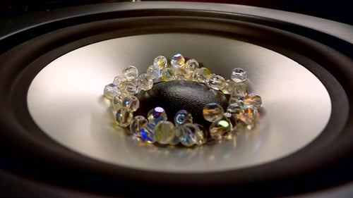 Transparent Beads Bouncing on a Speaker Cone
