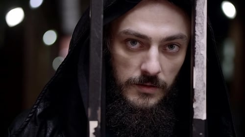 Man with Hood Behind Prison Bars