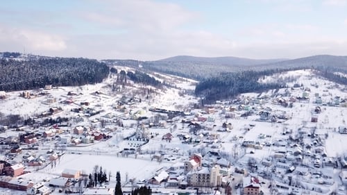Village with Buildings and a Visible Church All Covered with Snow