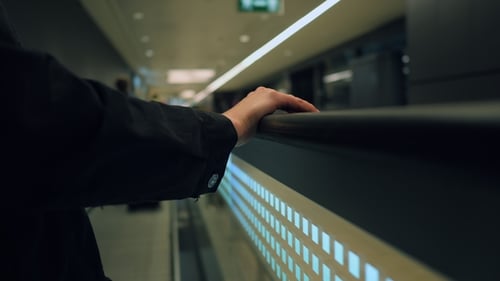 Airport Passageway, Unidentified Female Hand. Moving Walkway at Busy Airport. Travelator and People