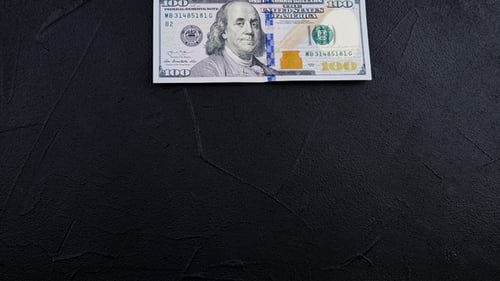 Stop Animation. One Hundred Dollar Note Turns Into a Big Money Pile. Multiplication of Capital