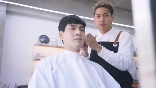 Man Getting a Haircut in a Bright Salon