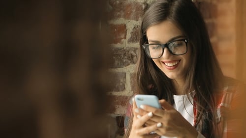 Young Woman Using Smartphone Indoors