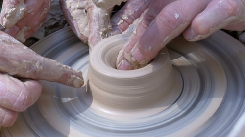Hands Molding Clay on a Pottery Wheel