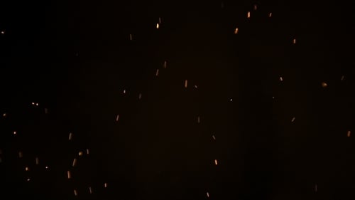 Burning Ash Rise From Large Fire in Black Background