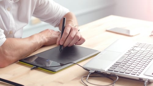 Young Man Drawing on a Graphic Tablet