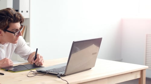Young Man Drawing on a Digital Tablet