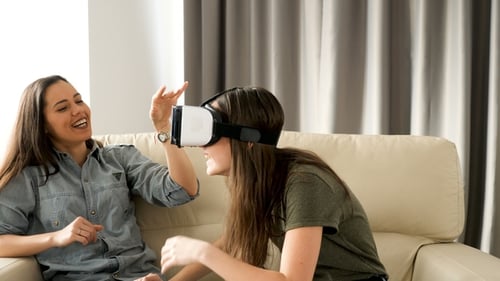Friends Experiencing Virtual Reality Technology at Home