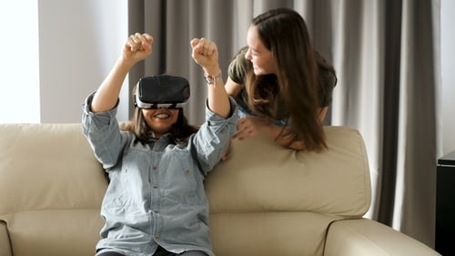 Woman Using VR Headset with Friend at Home