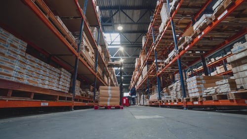 of a Busy Group of Workers in a Warehouse or Factory