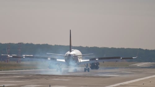 Airplane Landing Smoothly on Airport Runway in Daytime