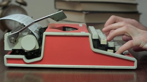 Typing on a Red Vintage Typewriter Machine