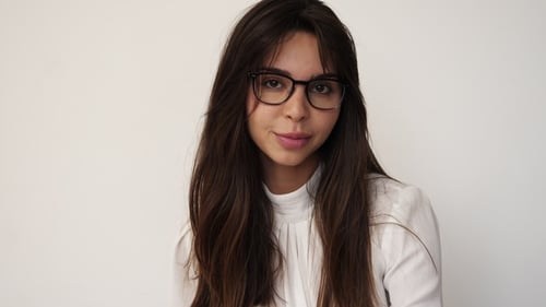 Stylish Woman Posing With Eyeglasses Against White Background