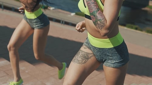 Women Doing Run Up on Staircase. Female Athlete Climbing Stairs Outdoors