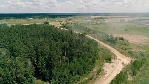 Car Driving on Dirt Road Seen From Above