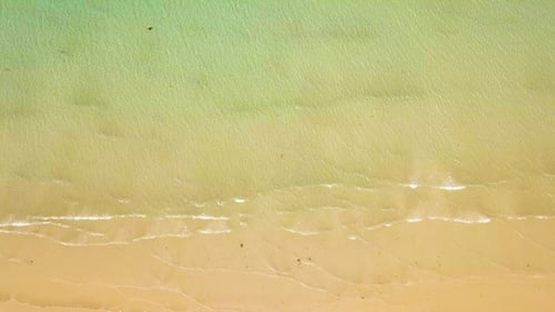 Sea Waves of Transparent Water on Sandy Beach Drone View. Top View Clear Ocean Waves Splashing on