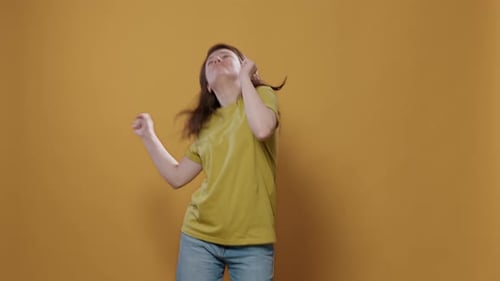 Portrait of Smiling Happy Young Person Dancing Alone in Studio Feeling Confident Moving to the Rithm