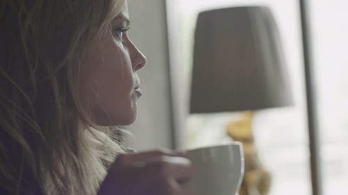 Happy Smiling Woman Drinking Cup of Coffee in Cafe