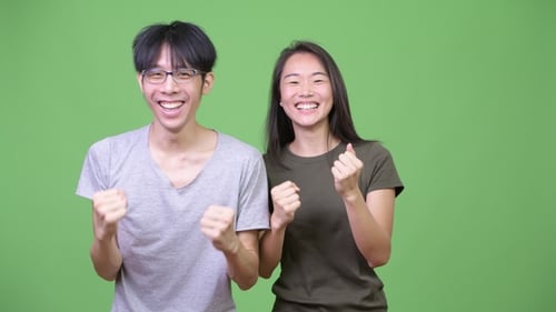 Young Asian Couple Getting Good News Together