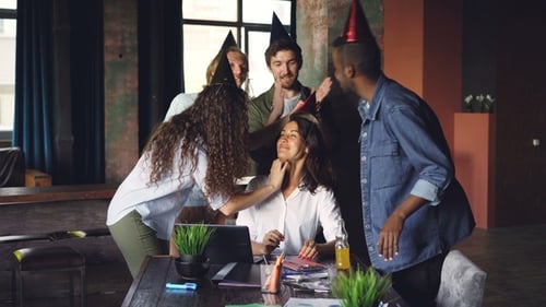 Pretty Woman Is Working in Modern Office When Her Colleagues Are Bringing Birthday Cake and Party