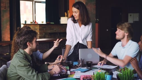 Young Men and Women Workgroup Are Talking Then Doing High Five During Meeting in Office