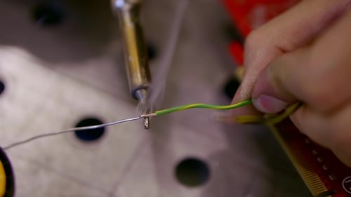Soldering Wires Onto Circuit Board Close Up