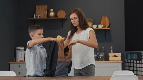 Mom Prepares Lunch for Her Son at School