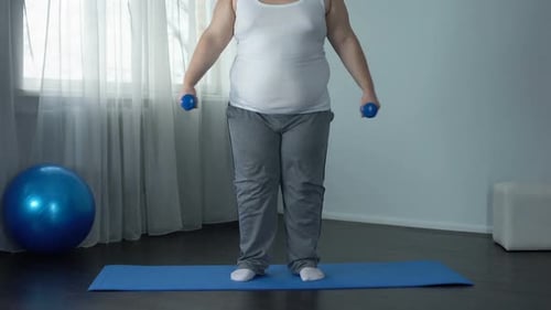 Adult Exercising with Dumbbells at Home