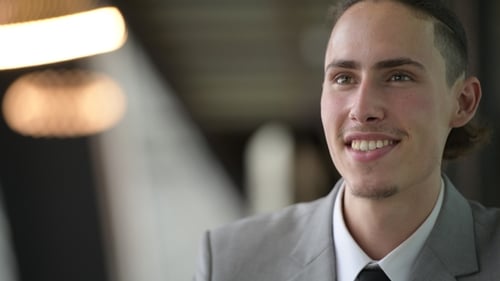 Man in Gray Suit Smiling in an Office