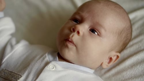 Adorable Baby Lying on White Blanket