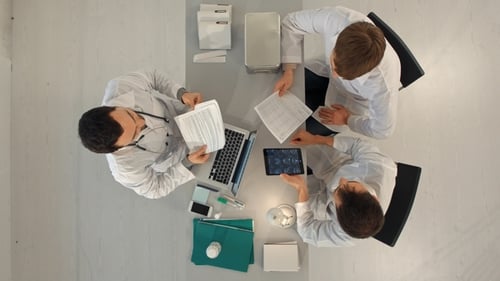 Top View of Team of Doctors Having a Meeting in Medical Office