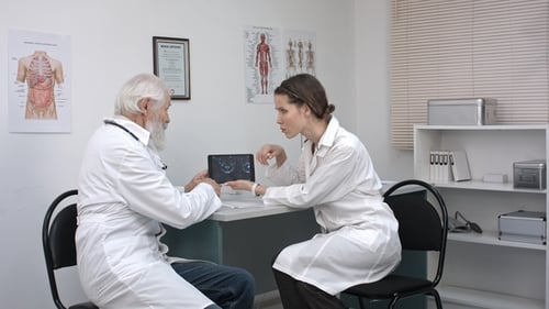 Doctors Discussing Medical Scan in Office Setting