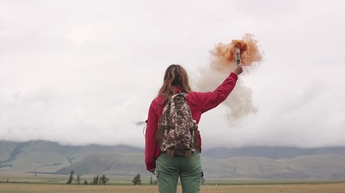 Woman Hiker Holding a Smoke Grenade Outdoors