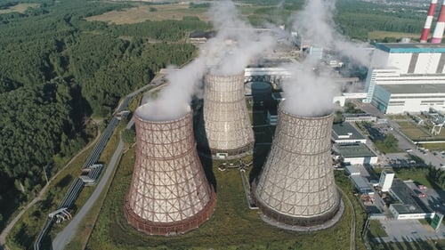 Aerial View on the Working Power Station. Cooling Tower of Nuclear Power Plant. Coal-burning Power