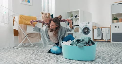 Mother and Child Playing in Laundry Room