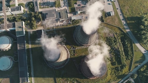 Aerial View on the Working Power Station. Cooling Tower of Nuclear Power Plant. Coal-burning Power