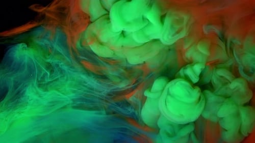 Colorful Rainbow Paint Drops From Above Mixing in Water