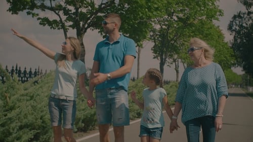 Family Walking Together on Path on Sunny Day
