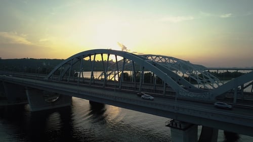 Aerial Footage. Fly Backward Near Kyiv Bridge at Sunset