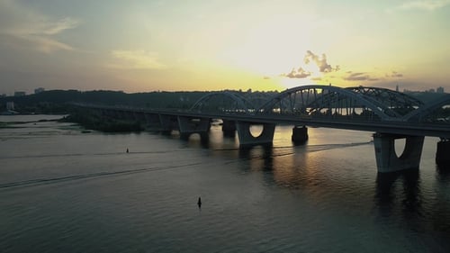 Aerial Footage. Fly Rise Above Kyiv Bridge at Sunset
